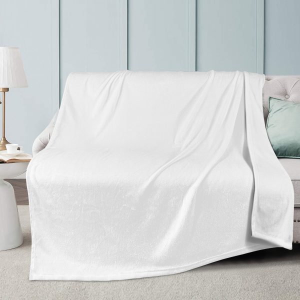 A white customizable wool blanket sits on the sofa